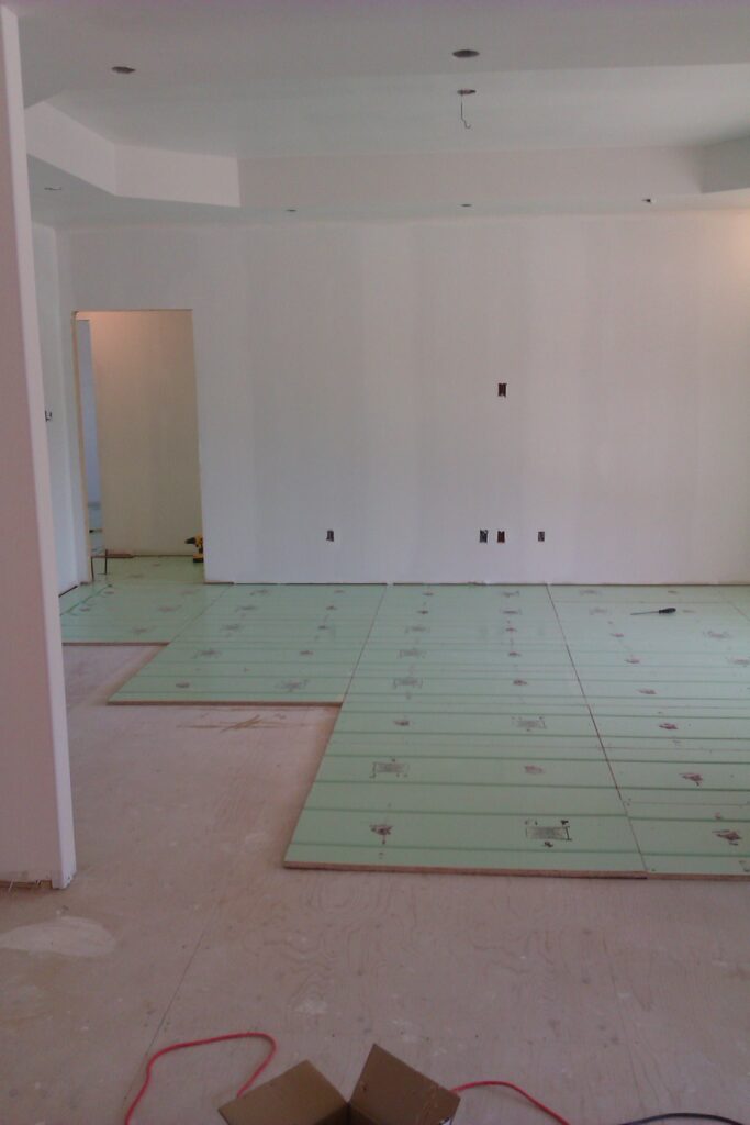 Warmboard panels being laid in a room during installation