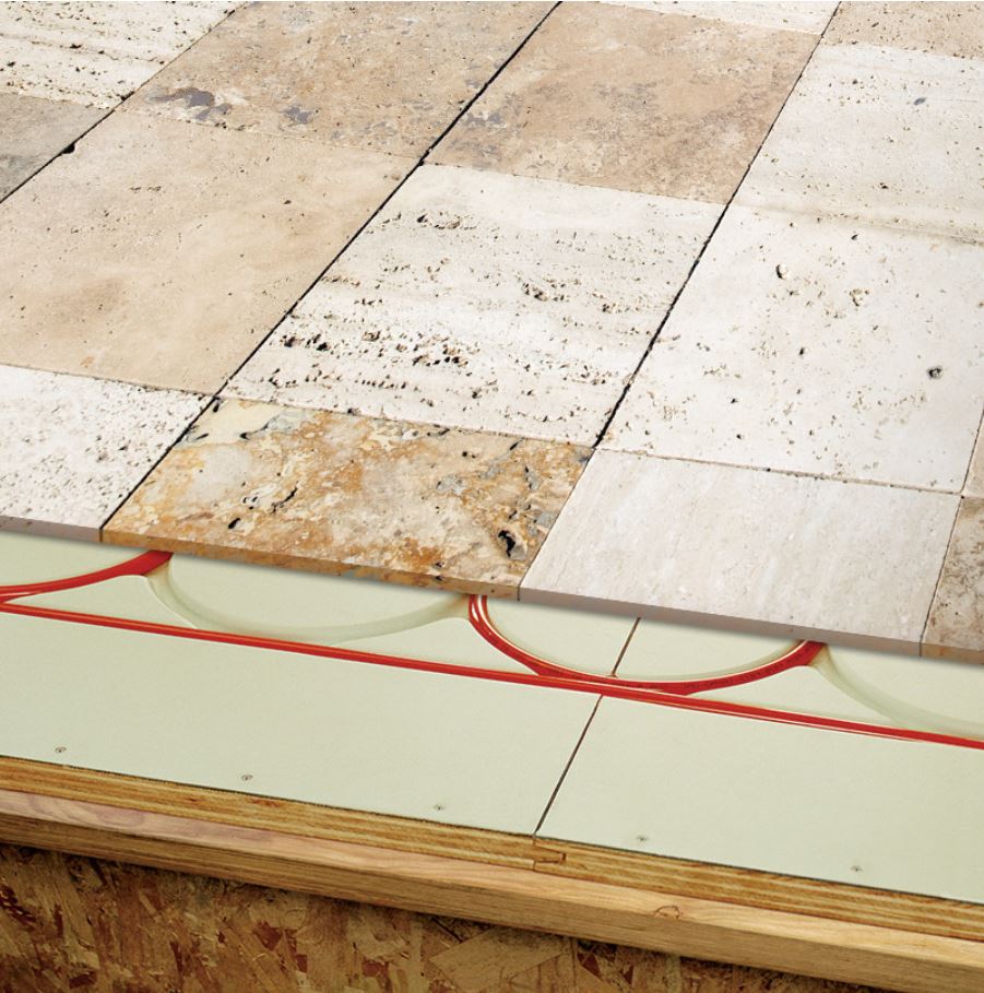 Stone floor tiles laid over Warmboard panels with pipe in the channels
