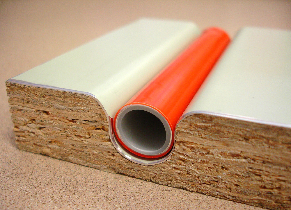 Cross-section of a Warmboard-R panel showing the pipe in its aluminium-faced channel