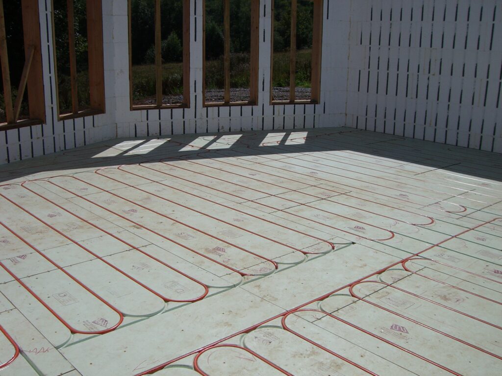 Warmboard panels with pipe laid in loops across a whole room before the floor covering