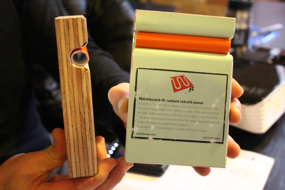 Warmboard sample pieces held in hand, showing the panel and pipe